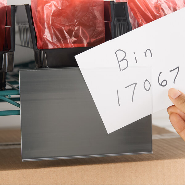 A gray 4 x 6 inch snap-on decking label holder attached to a wire shelf.