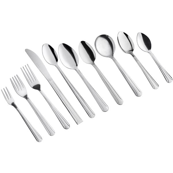 A set of stainless steel forks, knives, and spoons arranged in a row.