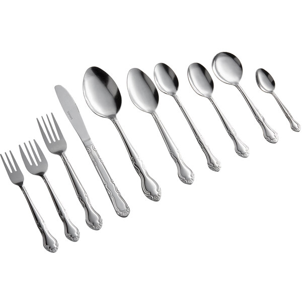 An assortment of stainless steel flatware including forks, knives, and various sizes of spoons arranged in a row.