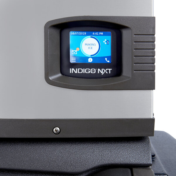 A Manitowoc Indigo NXT iP0800 air-cooled full dice cube ice machine with a digital display panel.
