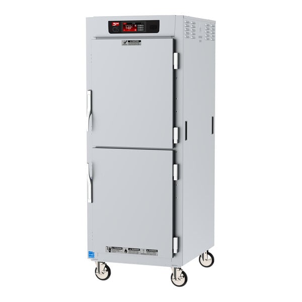 A white metal Metro C5 holding cabinet with two solid Dutch doors.