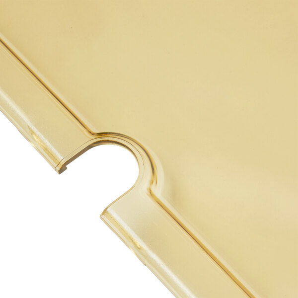 A Vollrath Super Pan amber high heat slotted cover with a hole in the middle.