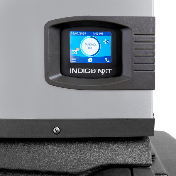 A Manitowoc Indigo NXT iP1000 air-cooled full dice cube ice machine with a digital control panel.