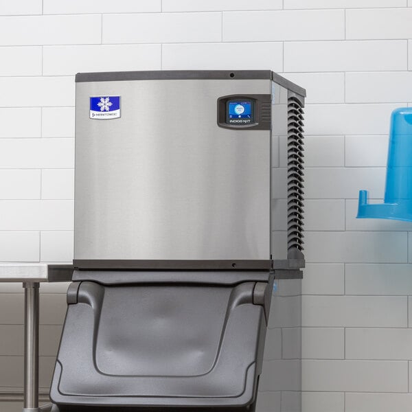A stainless steel air-cooled ice machine with a black dispenser, designed for commercial use.