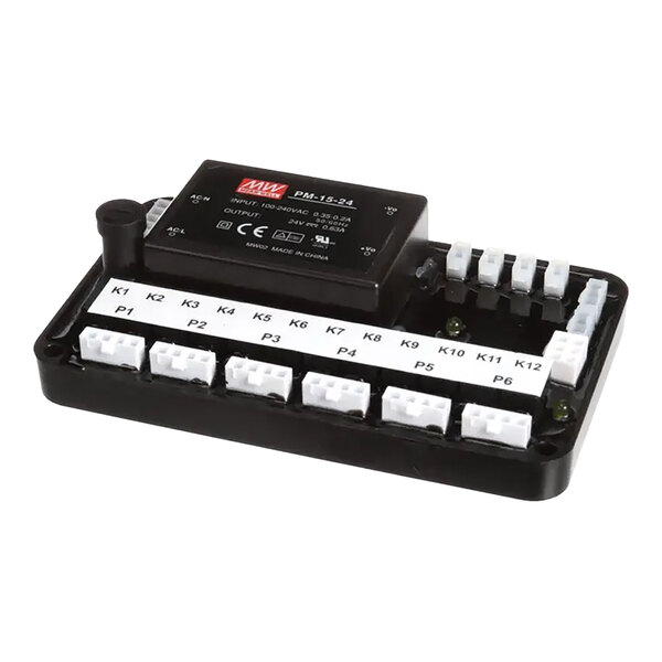 A black electronic I/O module kit with multiple labeled white connectors and a power supply unit mounted on top.