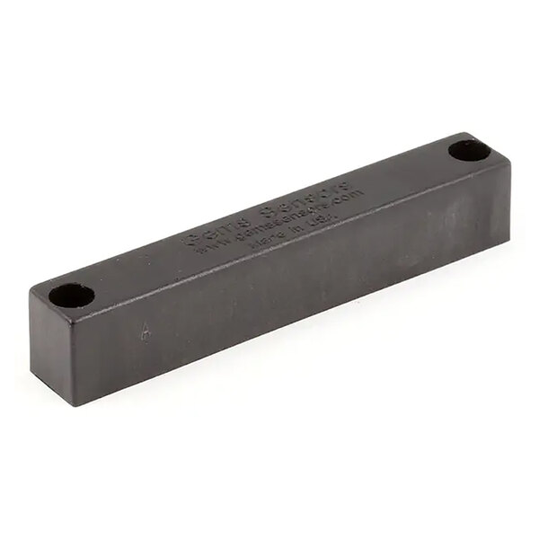 A rectangular black magnet with two holes, designed for use with a reed switch.
