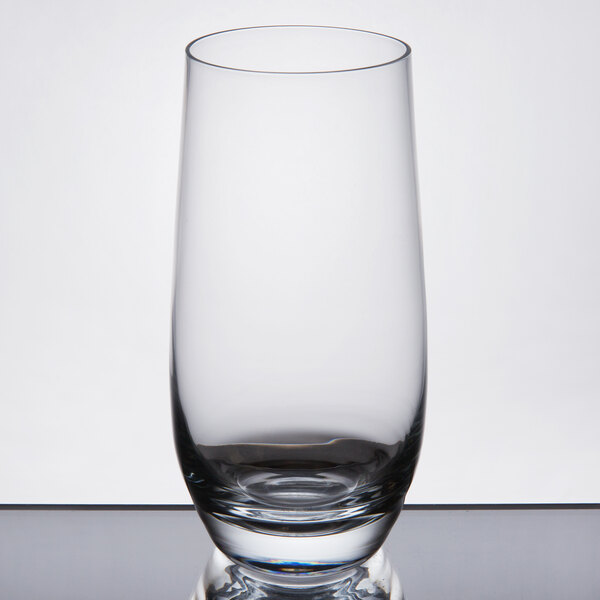 A Stolzle Grand Cuvee Collins glass on a table.