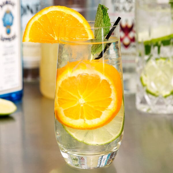 A Stolzle Grand Cuvee longdrink glass with water, orange, and mint.