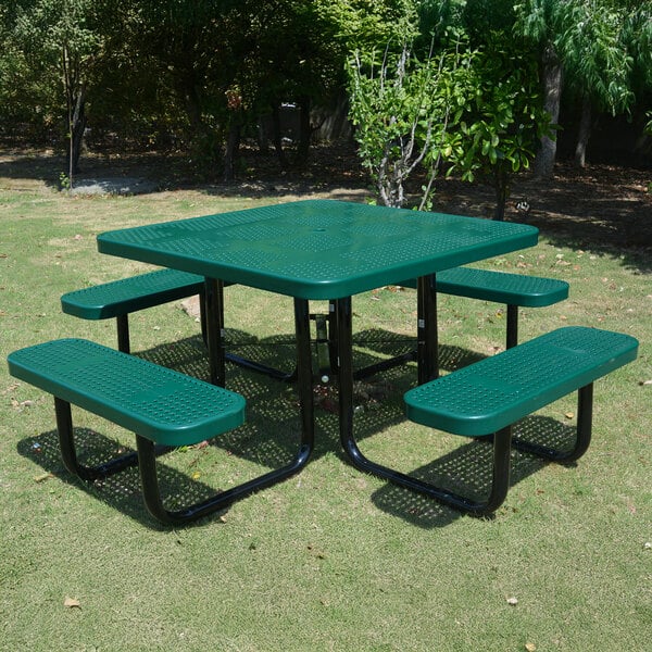 A green square perforated metal picnic table with attached benches.