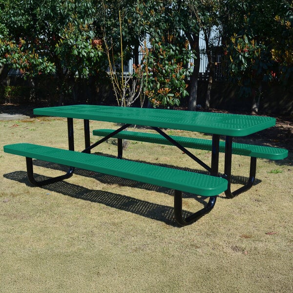 A green perforated metal picnic table with attached benches and black metal legs, designed for outdoor use.