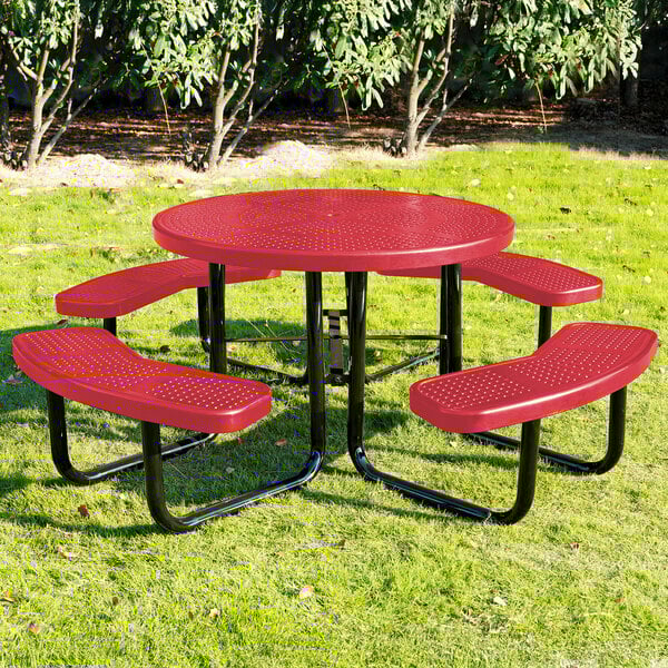 A round red perforated metal picnic table with four attached curved benches and black metal legs.
