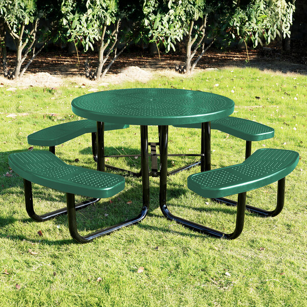 A round green perforated metal picnic table with attached curved benches.