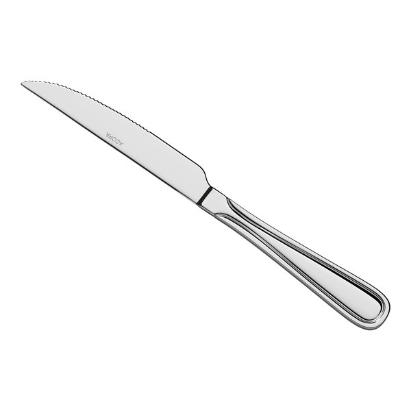 A stainless steel heavy weight steak knife with a serrated edge and a decorative handle.