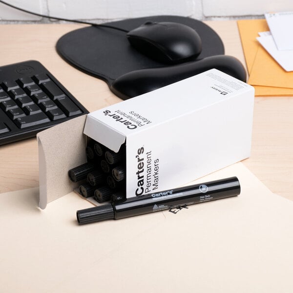 A box of Avery Carter's large black chisel tip desk style permanent markers with one marker placed outside the box.