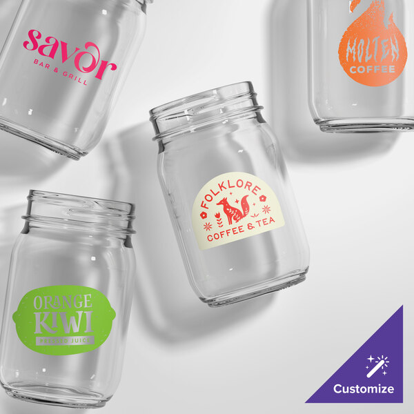 A set of clear, customizable plastic mason jars with various colorful logos and labels printed on them.
