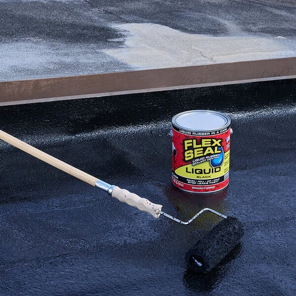 A can of Flex Seal black liquid rubber sealant coating with a paint roller being used to apply it.