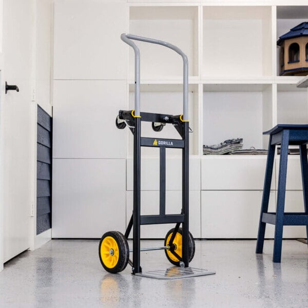 A steel convertible hand truck with two yellow wheels and a black frame, designed for heavy-duty lifting and transport.