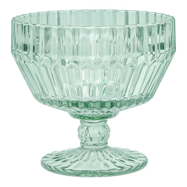 A green glass footed dessert bowl with a textured, faceted design.