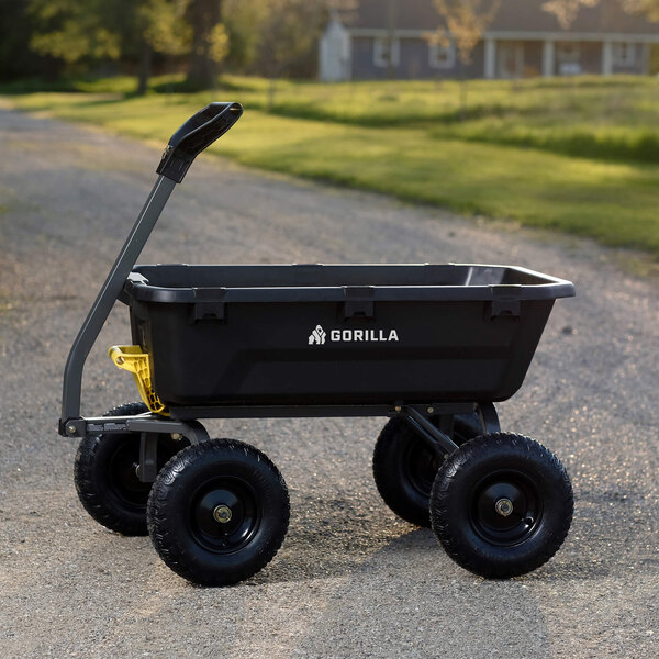 A black heavy-duty poly yard dump cart with four large wheels and a handle, labeled 'Gorilla' on the side.