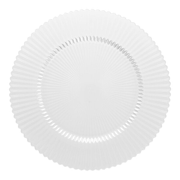 A clear round glass charger plate with a textured, radiating pattern.