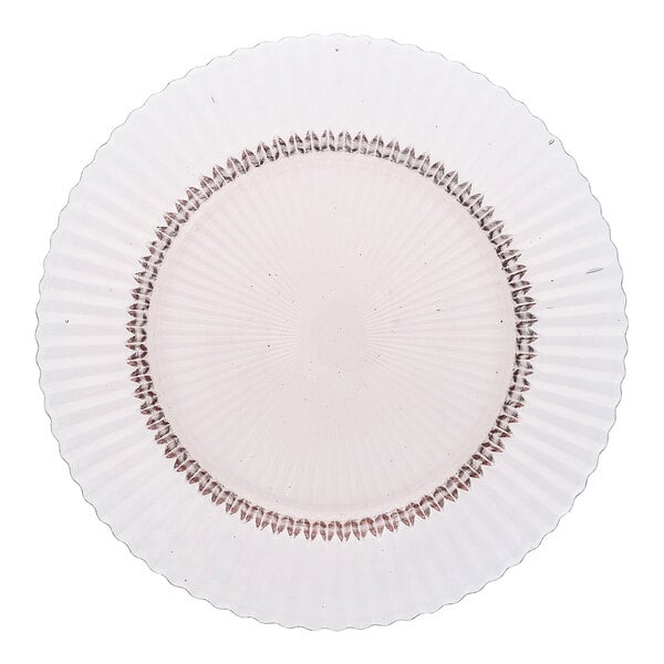A round pink glass dinner plate with a textured, radiating pattern.