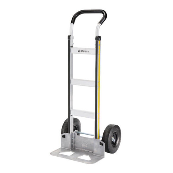 A silver and black aluminum hand truck with two wheels and a flat loading base.