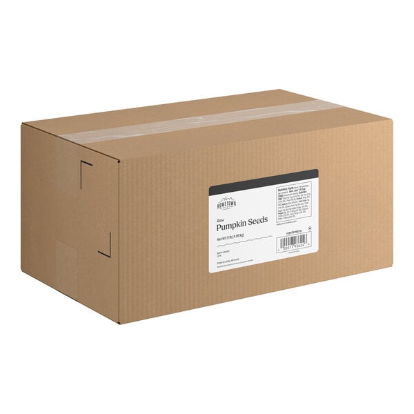 A large brown cardboard box with a white label indicating it contains raw pumpkin seeds.