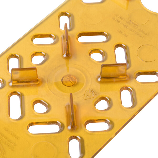 A yellow plastic Vollrath Super Pan drain tray with holes.
