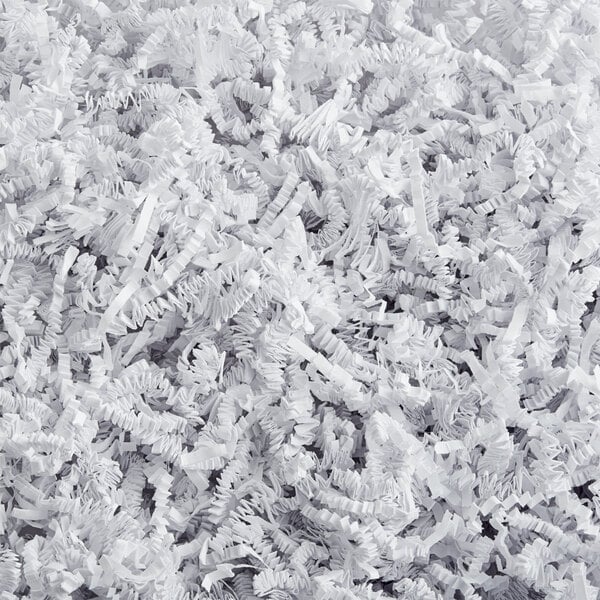 A pile of white crinkle paper shred used for packaging or gift baskets.