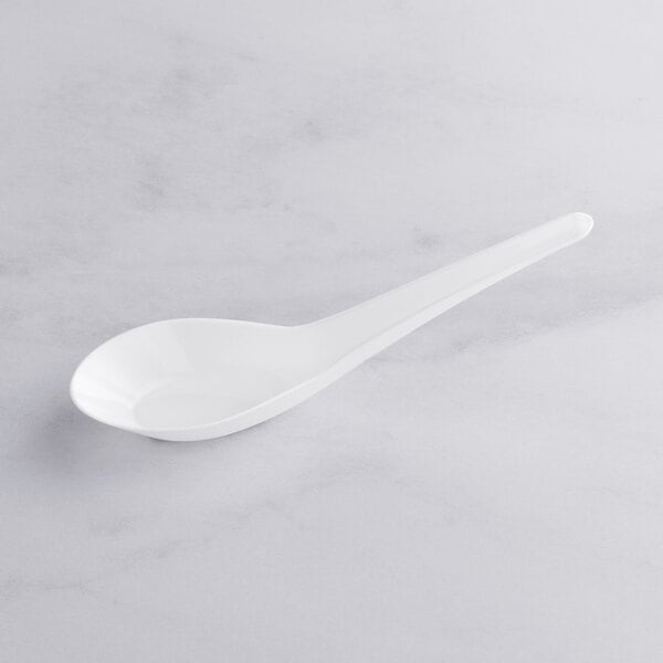 A white plastic Asian soup spoon with a long handle.