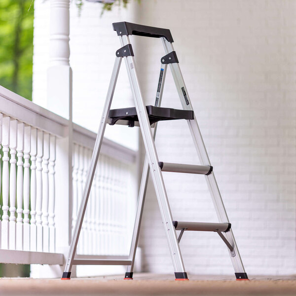 A three-step aluminum folding step stool ladder with a project tray.