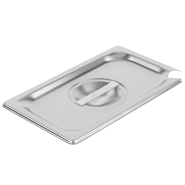 A Vollrath stainless steel slotted cover on a stainless steel pan.