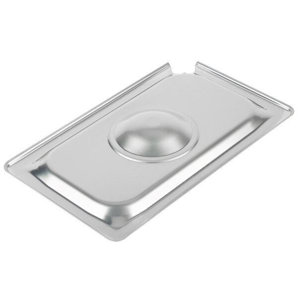 A Vollrath stainless steel slotted cover on a stainless steel pan.