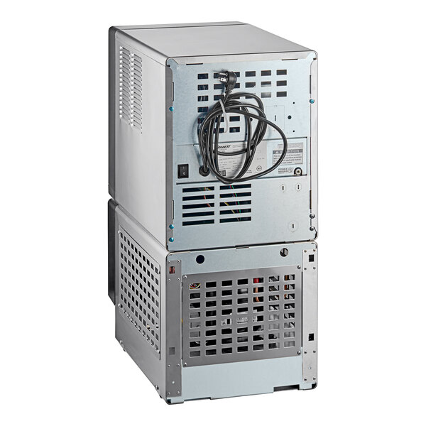 A commercial undercounter ice maker and water dispenser with a metal exterior and ventilation grilles.