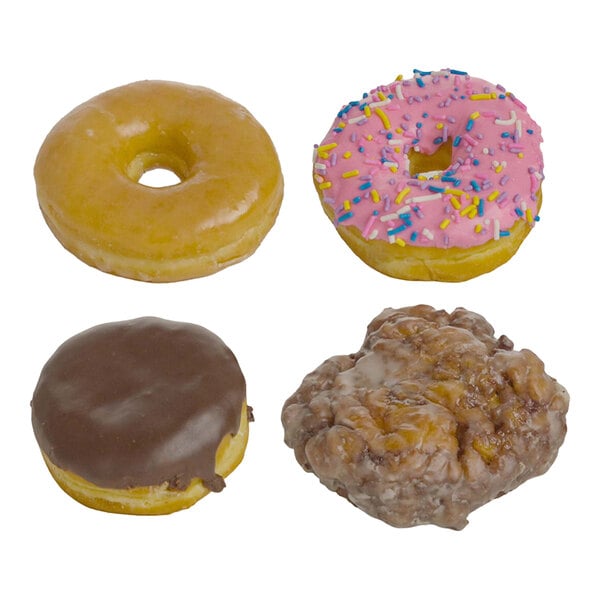 An assortment of four donuts including a glazed donut, a pink frosted donut with sprinkles, a chocolate frosted donut, and a glazed apple fritter.