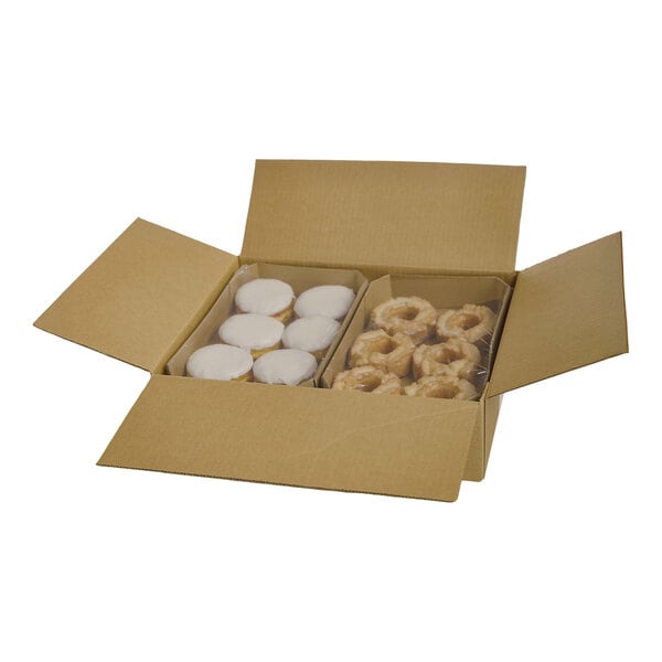 A cardboard box containing a variety pack of donuts, including iced and glazed types, arranged in two sections.