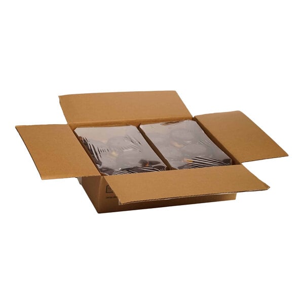 A cardboard box containing two plastic-wrapped trays of Boston creme donuts.