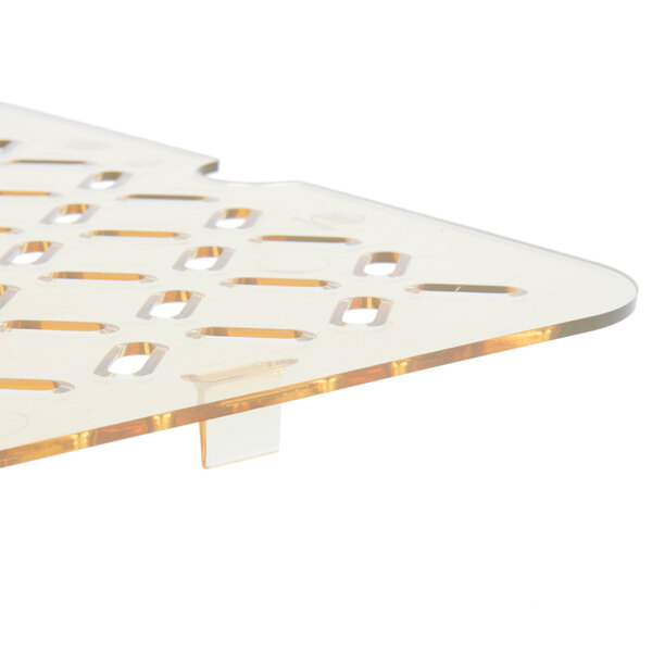 A Vollrath amber plastic drain tray with holes in it.
