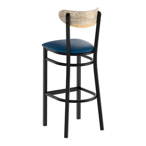 A black metal bar stool with a navy vinyl seat and a driftwood-finished wooden backrest.