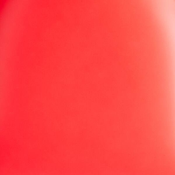 A chair with a black frame and red vinyl seat and back, shown unassembled.