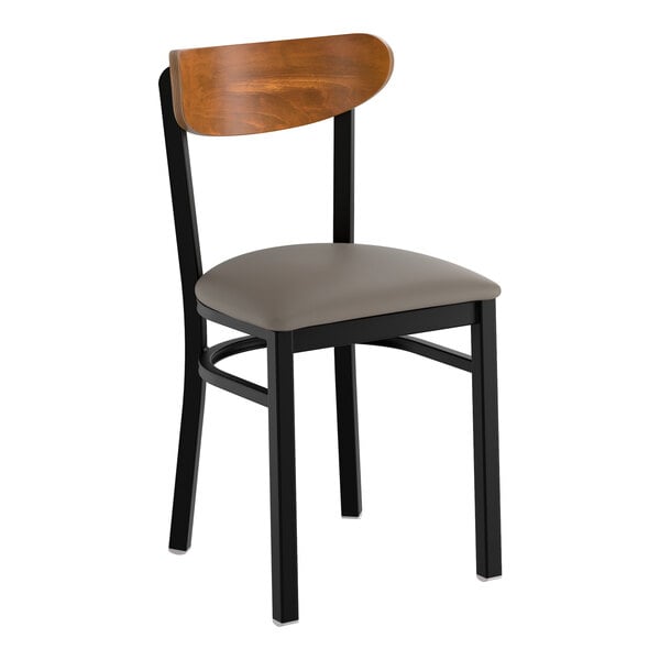 A black metal chair with a dark gray vinyl seat and a curved vintage wood backrest.