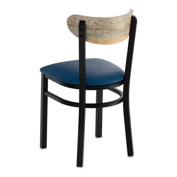 A black metal chair with a navy vinyl seat and a driftwood-finished curved wooden backrest.