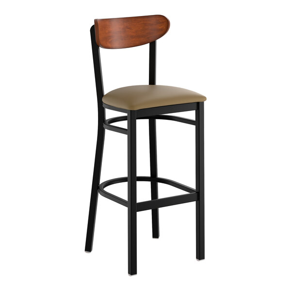 A black metal bar stool with a taupe vinyl seat and an antique walnut wood backrest.
