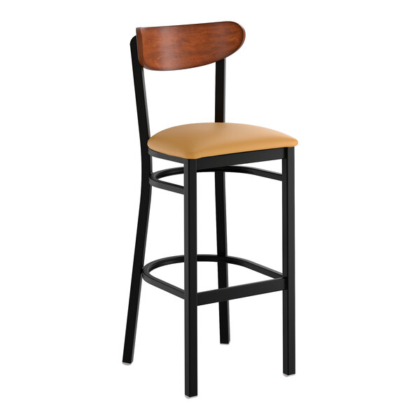 A black metal bar stool with a light brown vinyl seat and an antique walnut wood backrest.