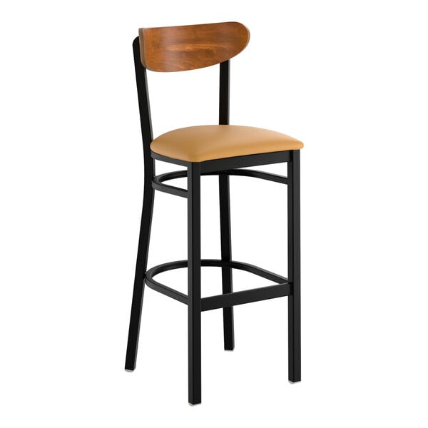 A black metal bar stool with a light brown vinyl seat and a curved wooden backrest.