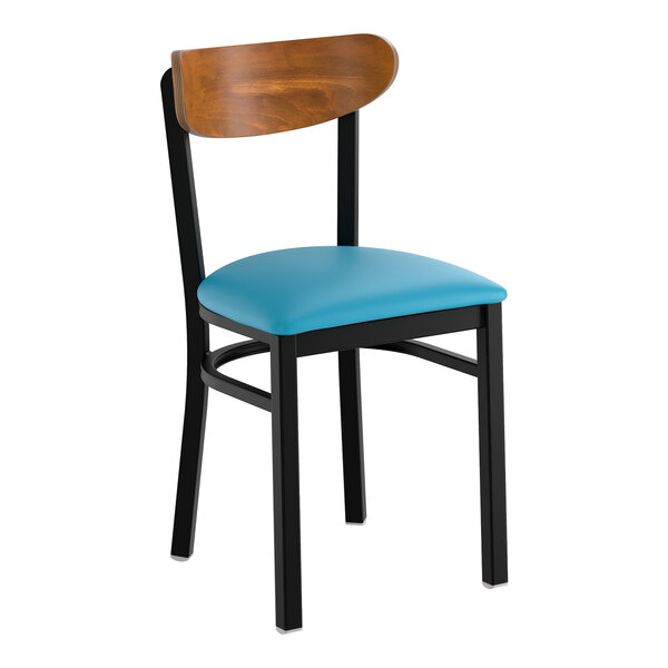 A black metal chair with a blue vinyl seat and a curved vintage wood backrest.
