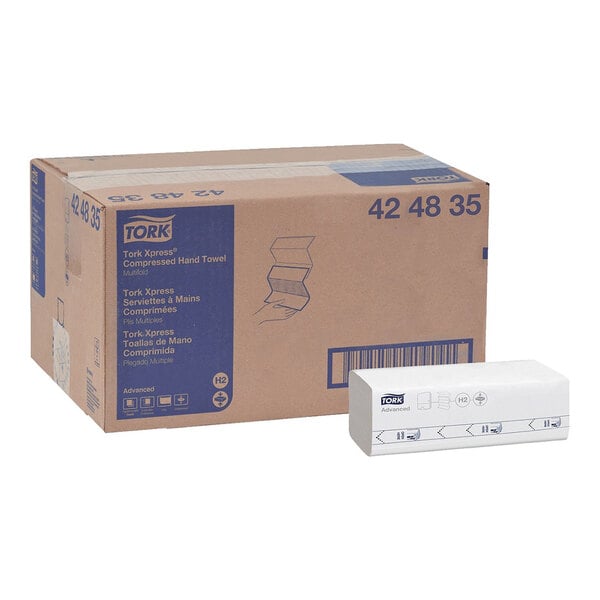 A case of Tork Advanced Xpress white compressed multi-fold paper towels with one pack displayed in front.