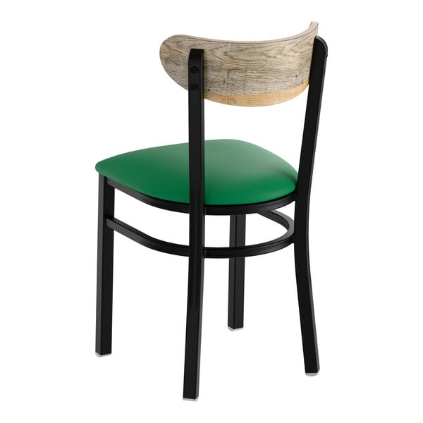 A black metal chair with a green vinyl seat and a driftwood-finished wooden backrest.