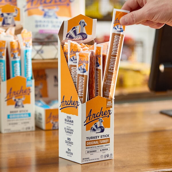 A box of Archer Original Turkey Meat Sticks, each individually wrapped, displayed on a counter.