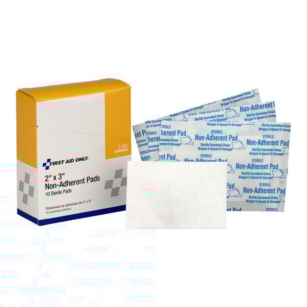 A box of First Aid Only 2" x 3" non-adherent sterile pads with individual pad packaging.